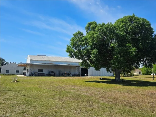 View of yard featuring an outdoor structure and an outbuilding