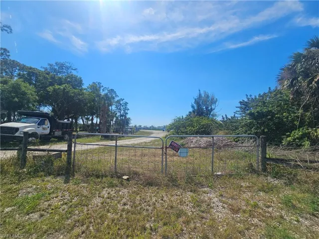 View of yard featuring fence and a rural view. Back private entrance.
