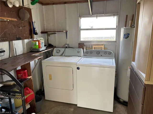 Washer, dryer, and water heater are located in the shed.