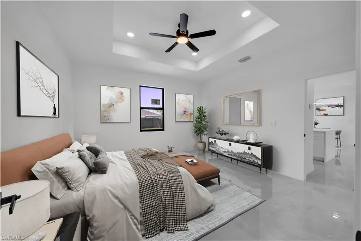Bedroom with recessed lighting, a raised ceiling, marble finish floors, and ceiling fan