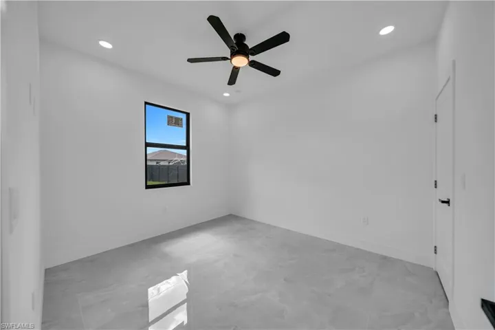 Unfurnished room with light marble finish floors, recessed lighting, and a ceiling fan