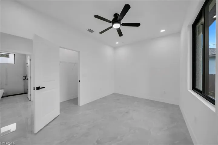 Spare room featuring light marble finish flooring, ceiling fan, and recessed lighting