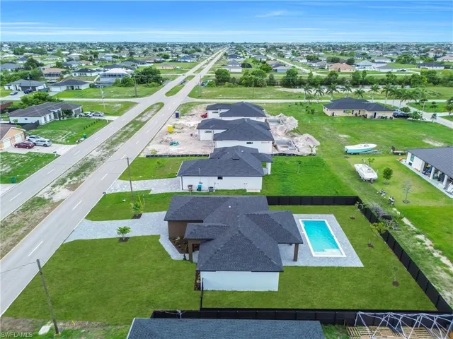Aerial perspective of suburban area featuring a pool
