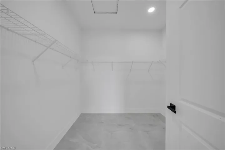 Spacious closet with light marble finish flooring