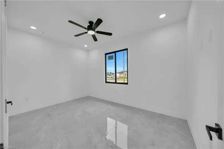 Unfurnished room with light marble finish floors, recessed lighting, and ceiling fan