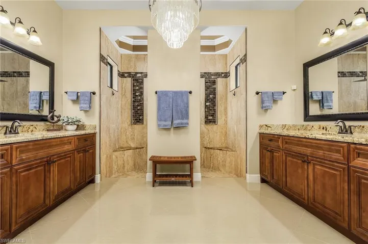Master Bath with separate sinks and gorgeous chandelier
