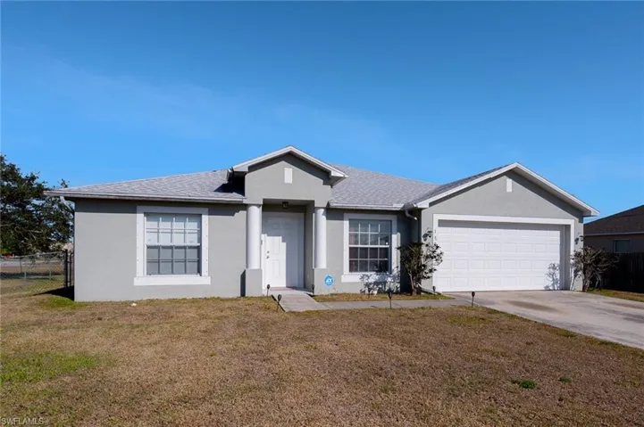 Single story home with front lawn and a two-car garage