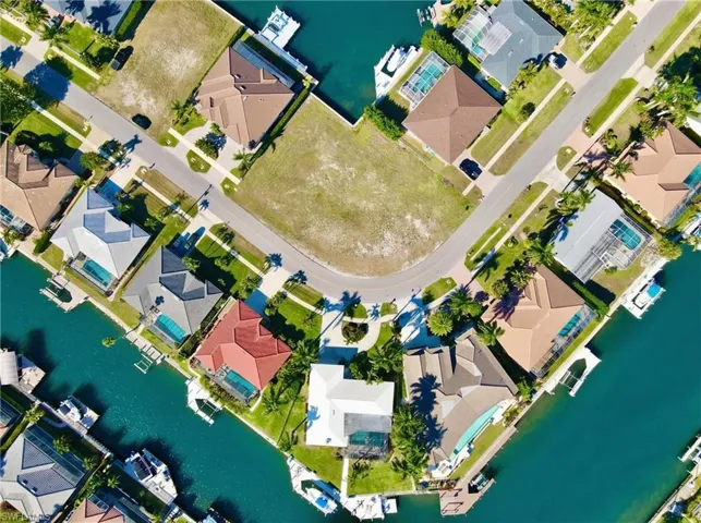 Aerial perspective of suburban area featuring a large body of water