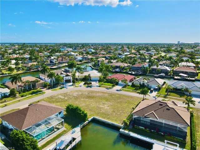 Aerial perspective of suburban area featuring a nearby body of water