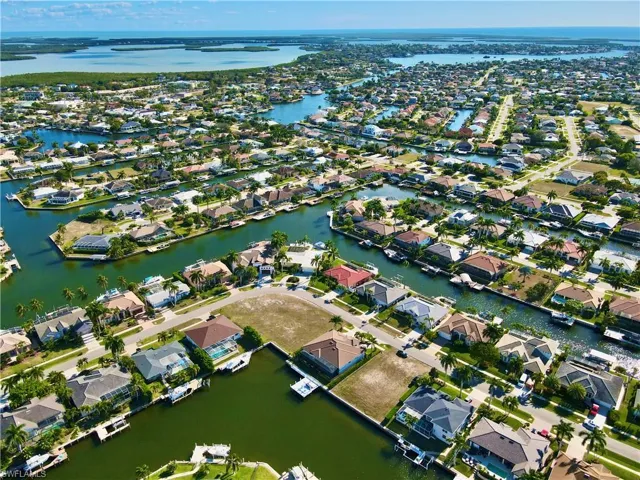 Aerial overview of property's location featuring nearby suburban area and a large body of water