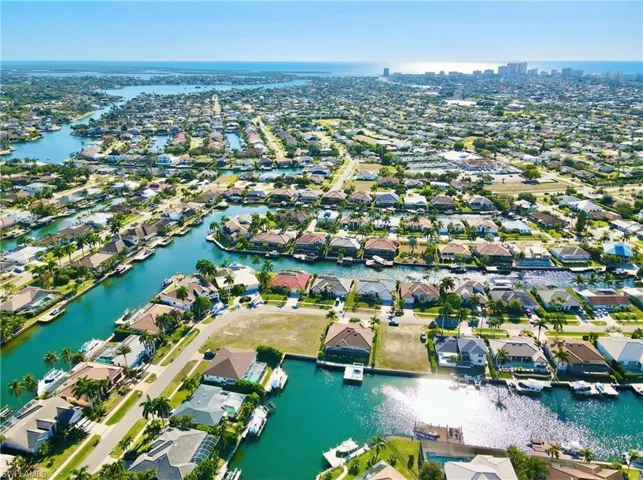 Aerial overview of property's location featuring nearby suburban area and a large body of water