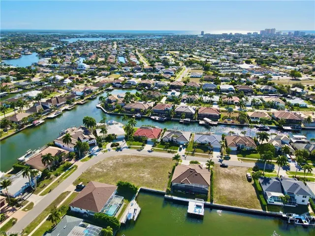 Aerial view of property's location with nearby suburban area and a nearby body of water