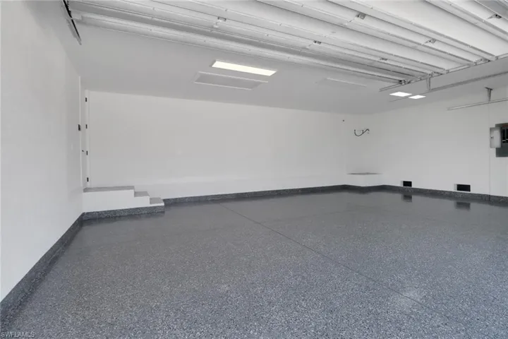 Large 3-car garage with epoxy floor and linear garage door openers