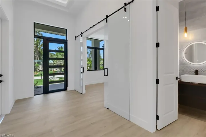 Foyer with double glass barn doors to flex room