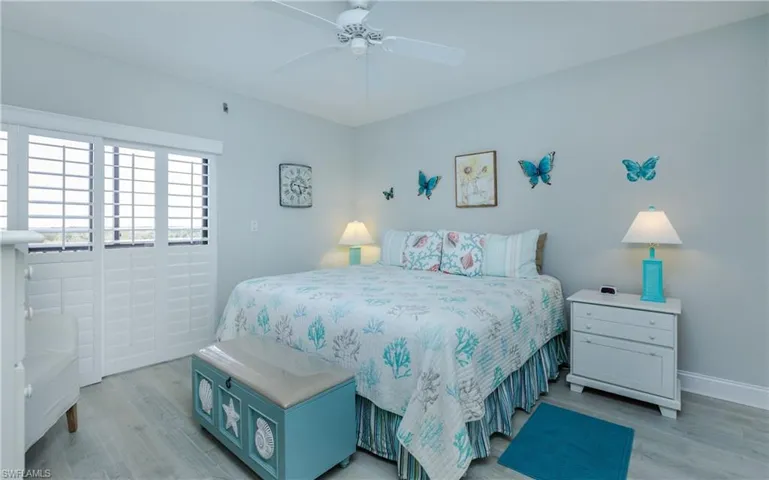 Bedroom with ceiling fan and light wood-style flooring