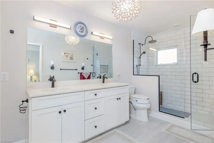 Full Bathroom with dual sinks, bath tub and separte shower
