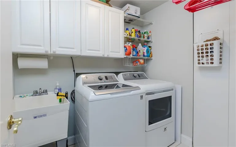 Laundry room with cabinet space and washing machine and dryer