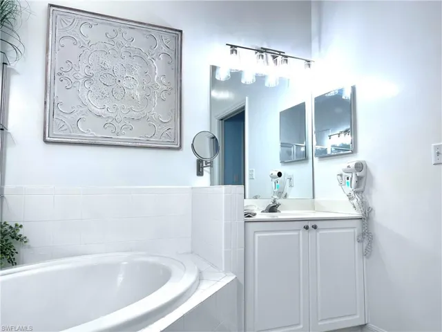 Bathroom featuring vanity and a garden tub