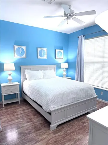 Bedroom featuring dark wood-style floors and ceiling fan