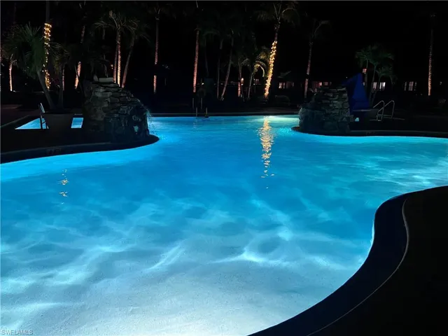 Pool at twilight featuring a community pool