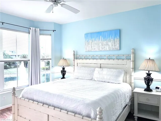 Bedroom with ceiling fan and wood finished floors