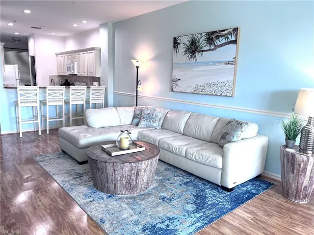 Living area featuring dark wood-style floors and recessed lighting