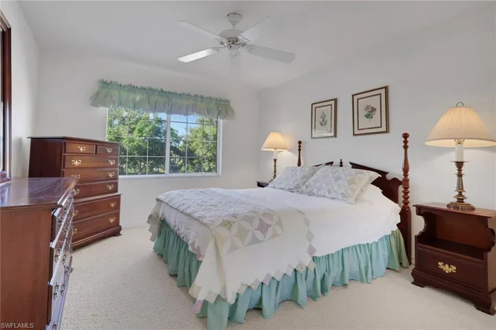 Bedroom with light colored carpet and ceiling fan