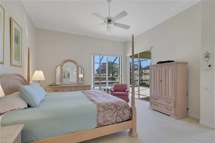 Carpeted bedroom featuring ornamental molding, access to exterior, and a ceiling fan