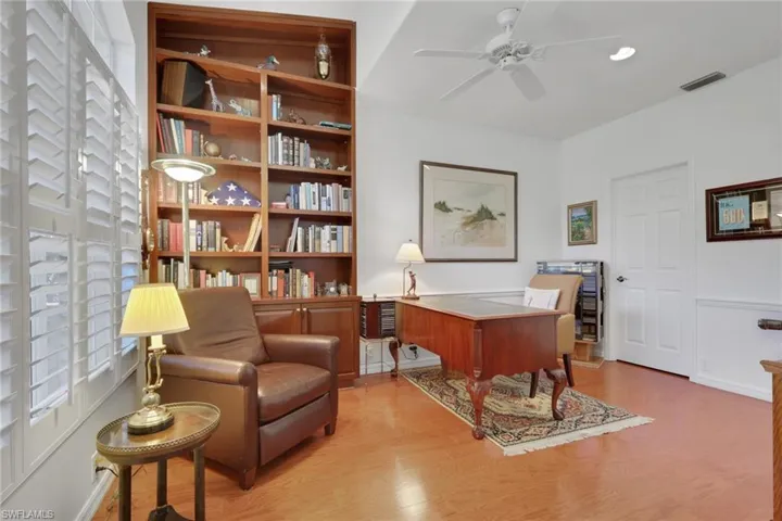 Office area featuring light wood-type flooring and a ceiling fan