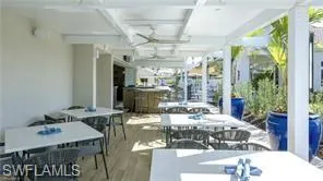 View of patio with outdoor dining area and ceiling fan
