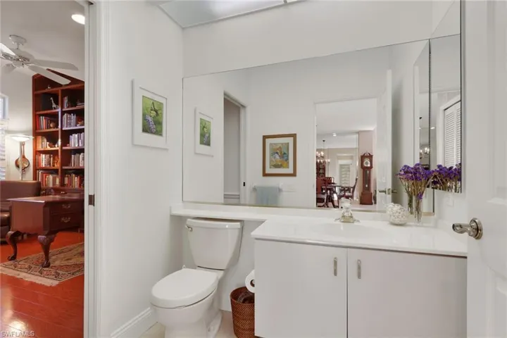 Bathroom featuring vanity, light wood-style floors, and ceiling fan