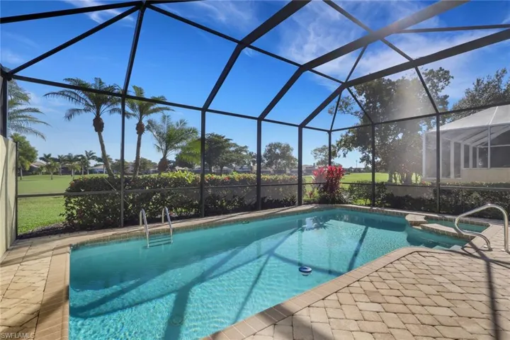 View of pool with a lanai, a sunroom, a pool with connected hot tub, and a patio