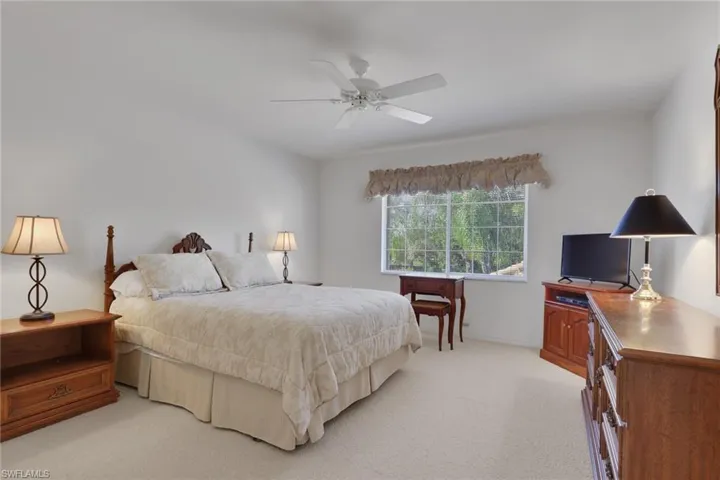 Bedroom featuring light carpet and a ceiling fan