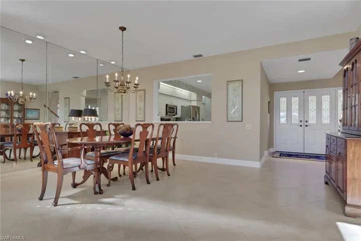 Dining room with recessed lighting and a chandelier
