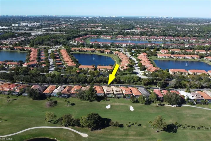 Aerial view of property and surrounding area with nearby suburban area and a large body of water