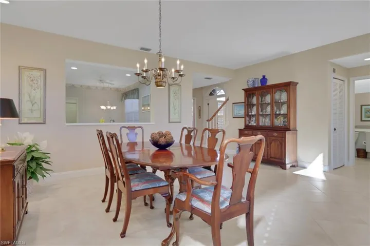Dining space featuring baseboards and a chandelier