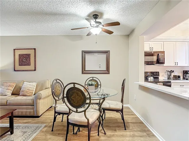 Dining room featuring light hardwood / wood-style floors, a textured ceiling, and ceiling fan
