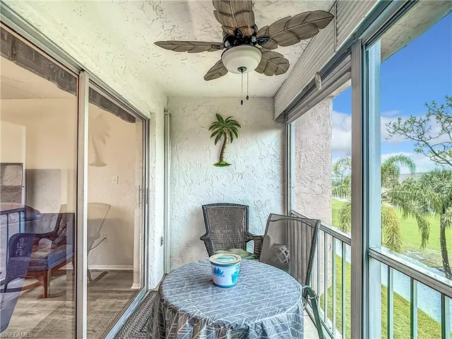 Sunroom / solarium featuring ceiling fan