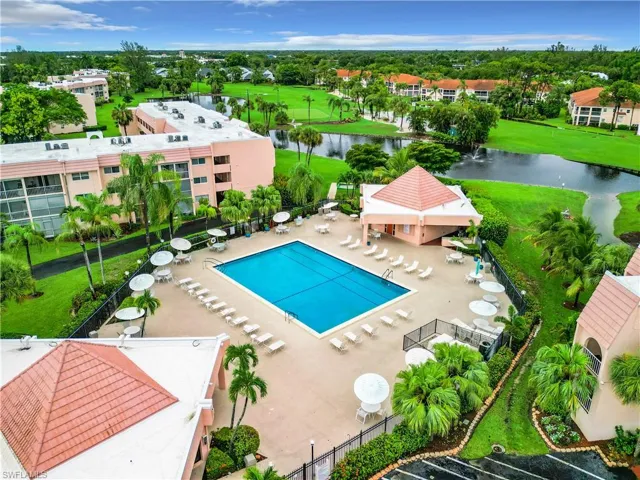 View of swimming pool with a water view, a yard, and a patio area