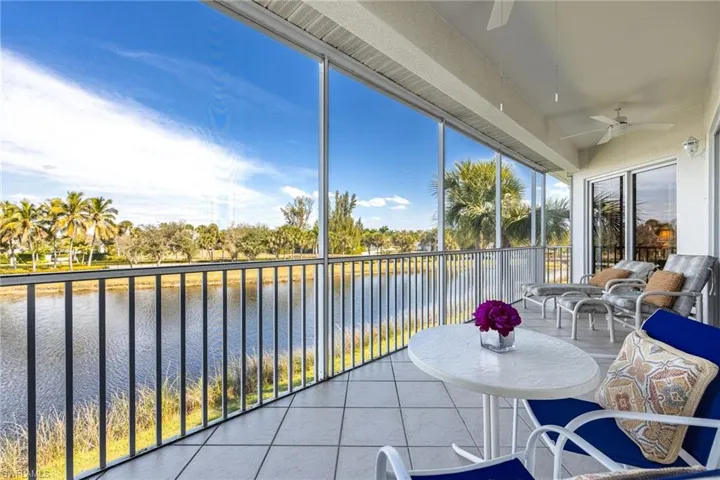 Sunroom featuring tile patterned flooring and a water view