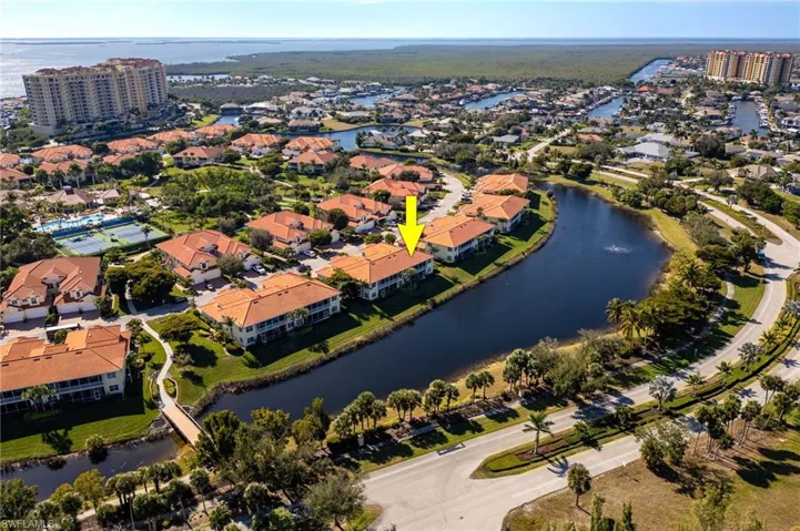 Aerial view of property and surrounding area featuring a nearby body of water