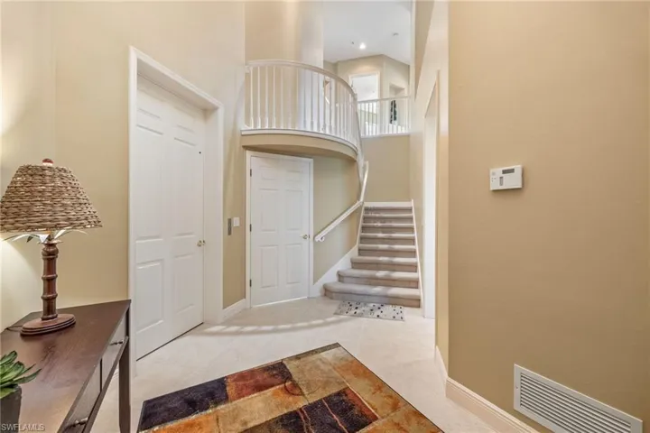 Foyer featuring a high ceiling and light tile patterned floors
