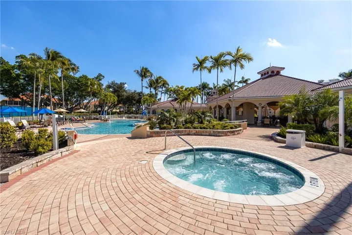 Community pool with a patio and a community hot tub