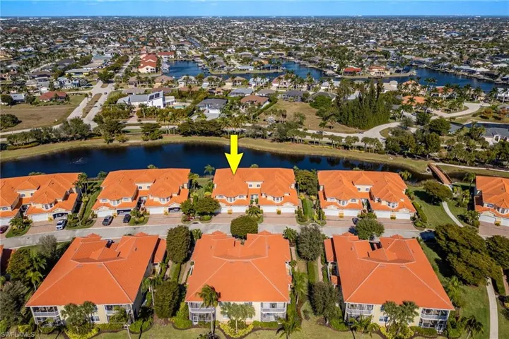Aerial perspective of suburban area featuring a large body of water
