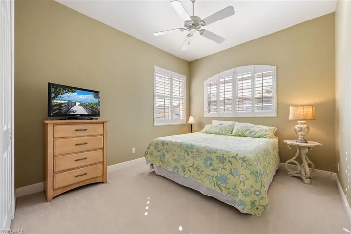 Bedroom featuring light colored carpet and ceiling fan