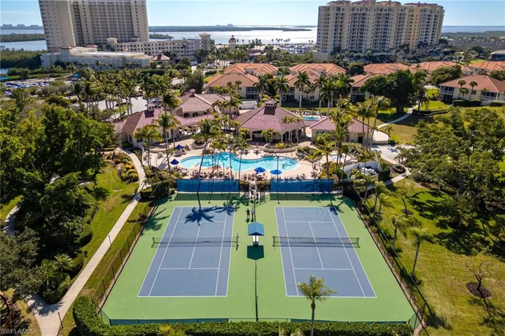 Bird's eye view of a nearby body of water and a pool area