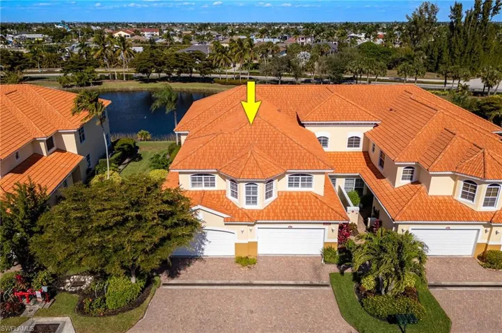 Aerial view of property and surrounding area featuring a nearby body of water