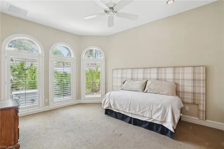 Spacious bedroom featuring ceiling fan