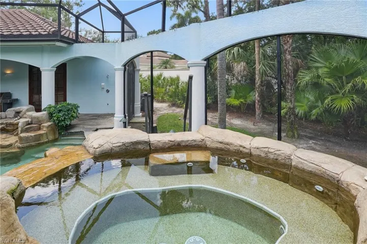 View of pool and elevated spa