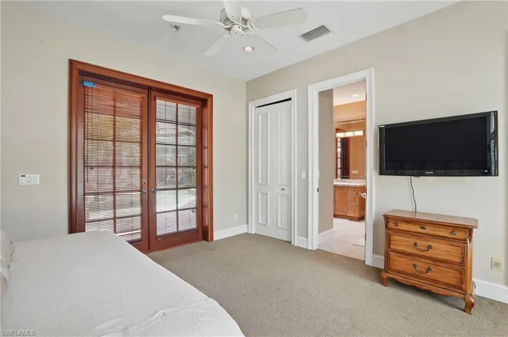 Bedroom featuring french doors, light carpet, baseboards, a ceiling fan, and recessed lighting